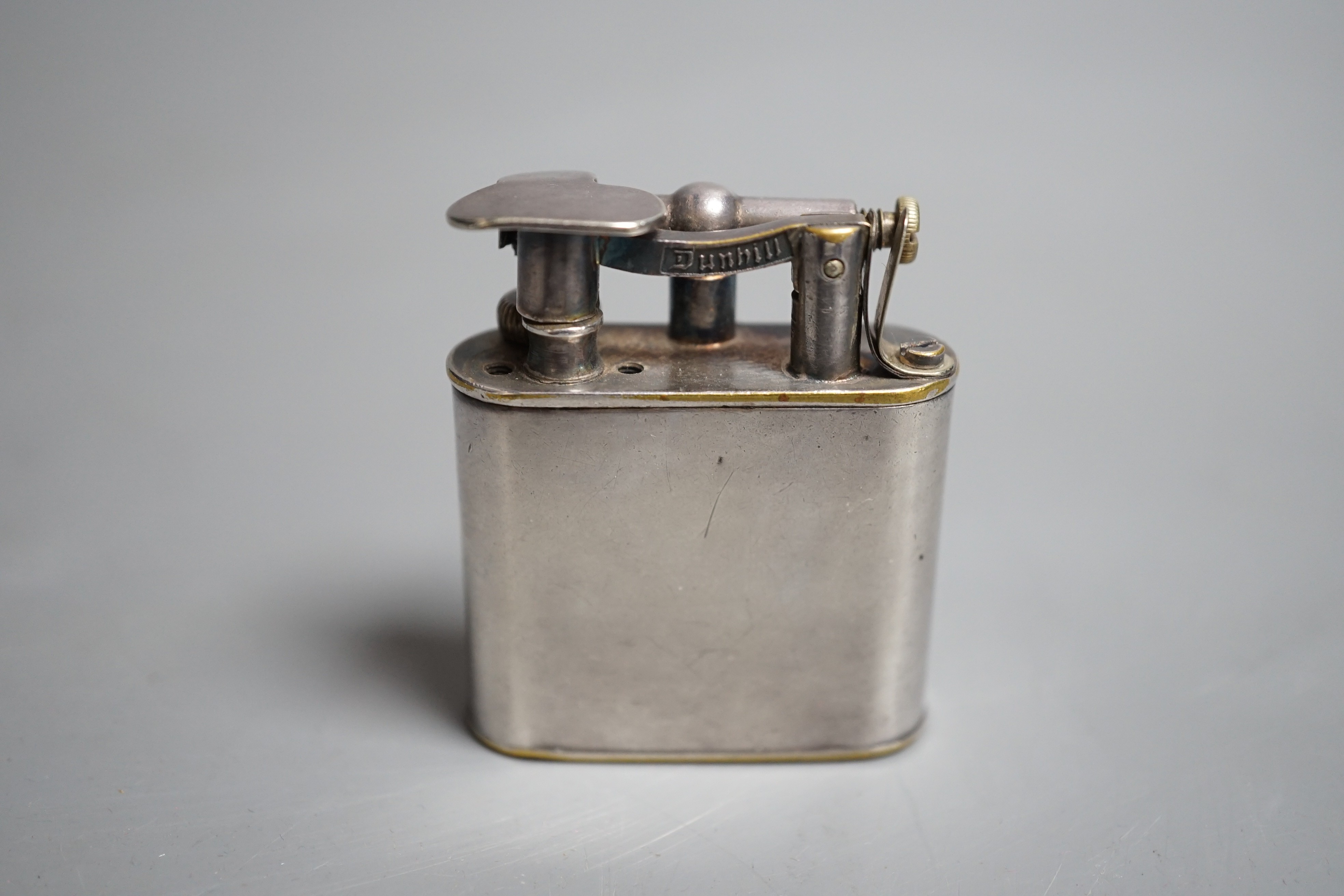 A vintage 1930’s Dunhill Unique Sports plated nickel cigarette lighter.